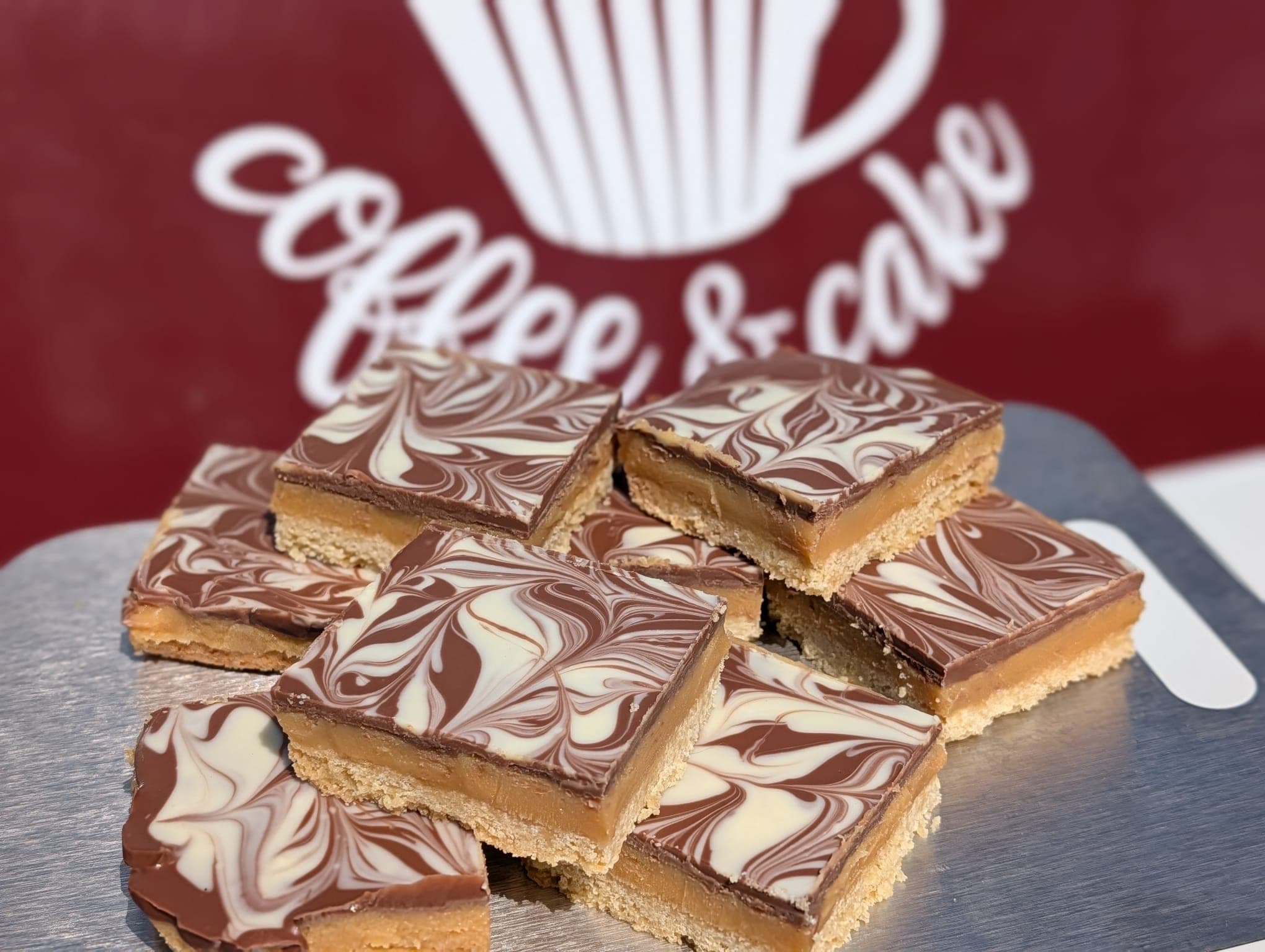 Squares of millionaire's shortbread with swirled milk and white chocolate topping